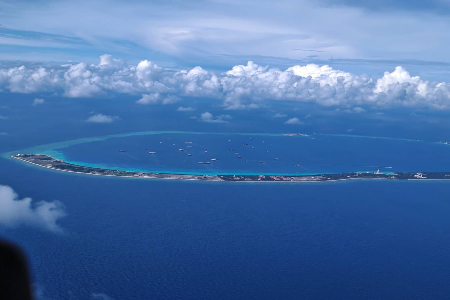 Aerial photograph of an island anchorage with numerous vessels, annotated in the manner of an imagery read: a datum rule with station ticks, a collection box drawn around the anchorage, six contacts marked within it, and callouts stating collection time, how many contacts are held, and which one has been adjudicated.